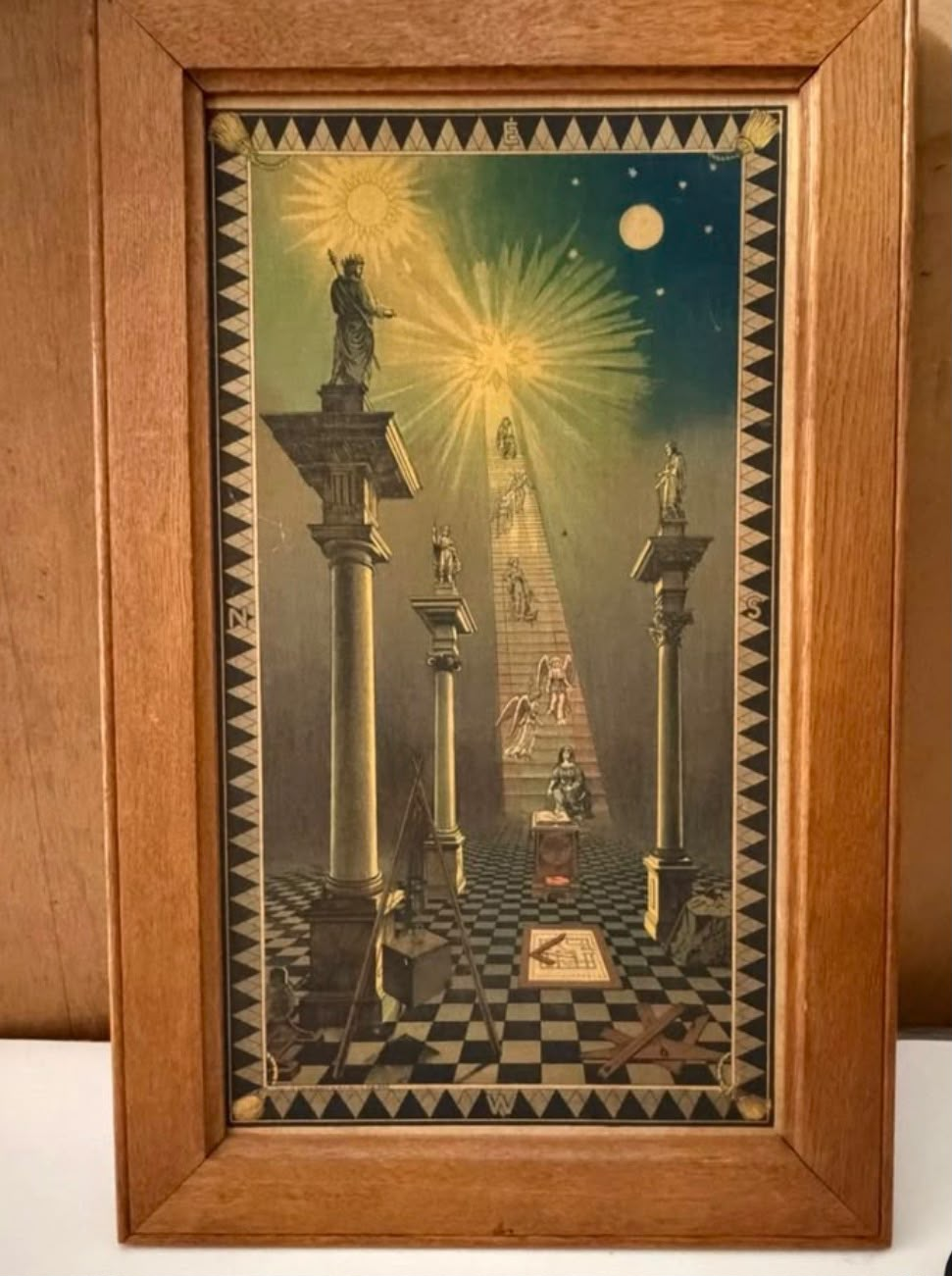 Framed antique Masonic tracing board with columns, chequered pavement, celestial symbols and a ladder ascending toward light